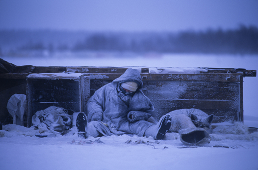 An Arctic ice fisherman in Russia waits a bite.