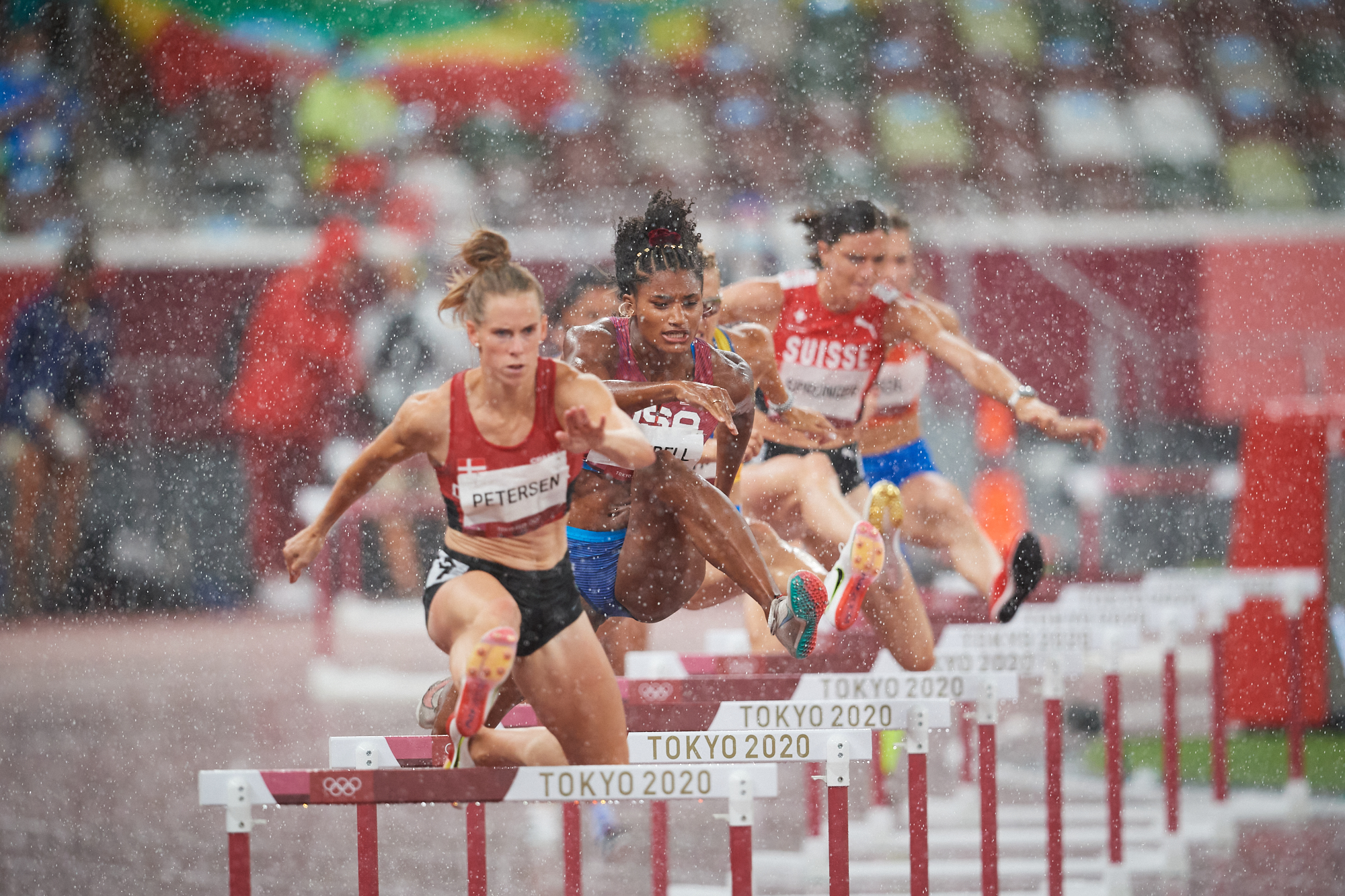 Photo of Team USA's Anna Cockrell  in the women's 400m hurdle semi-finals (in a rain storm) during the Tokyo 2020 Olympics at the Olympic Stadium in Tokyo, Japan.