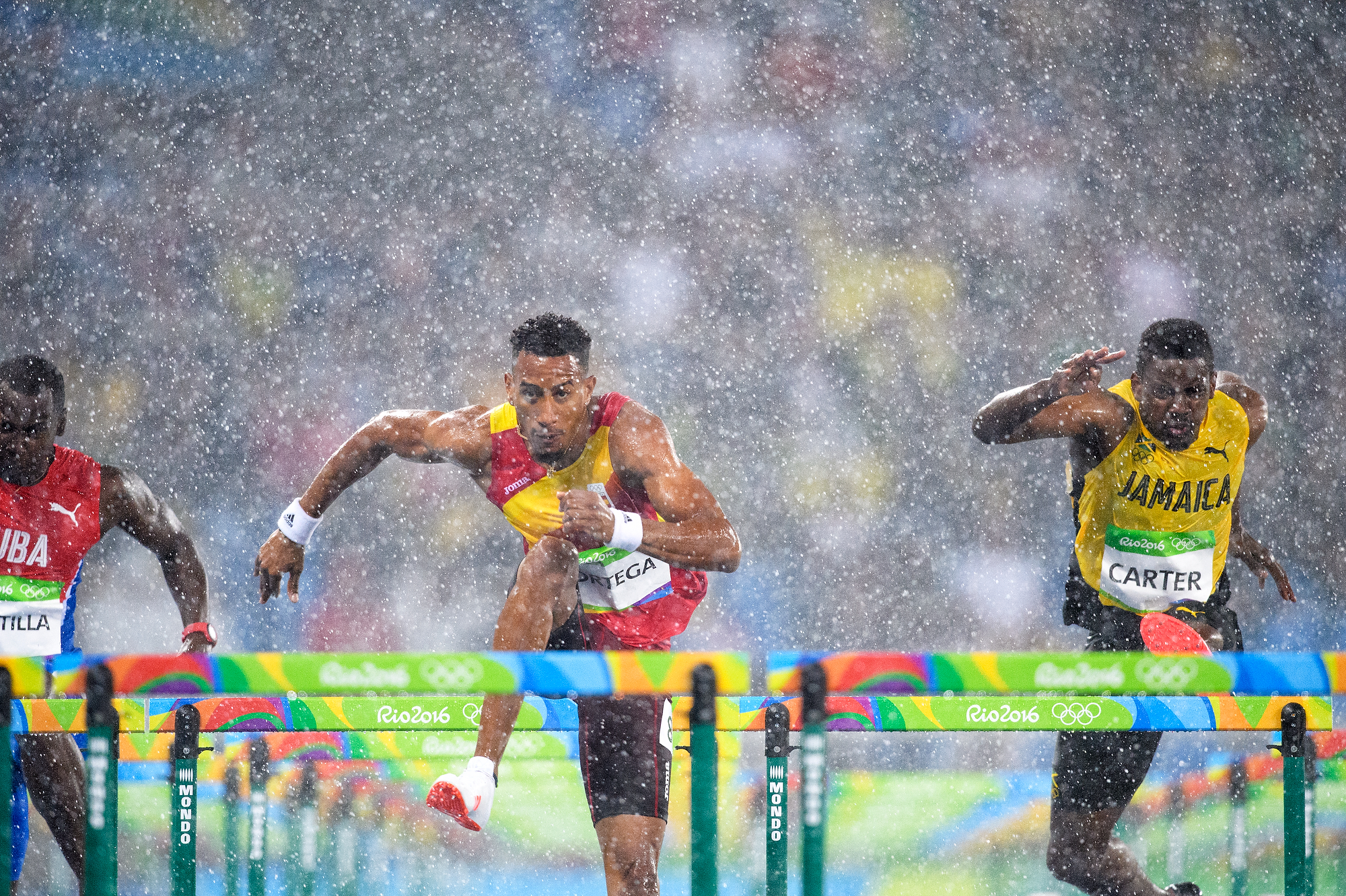 Photo of men's hurdle race in the rain during Rio 2016 Summer Olympics.