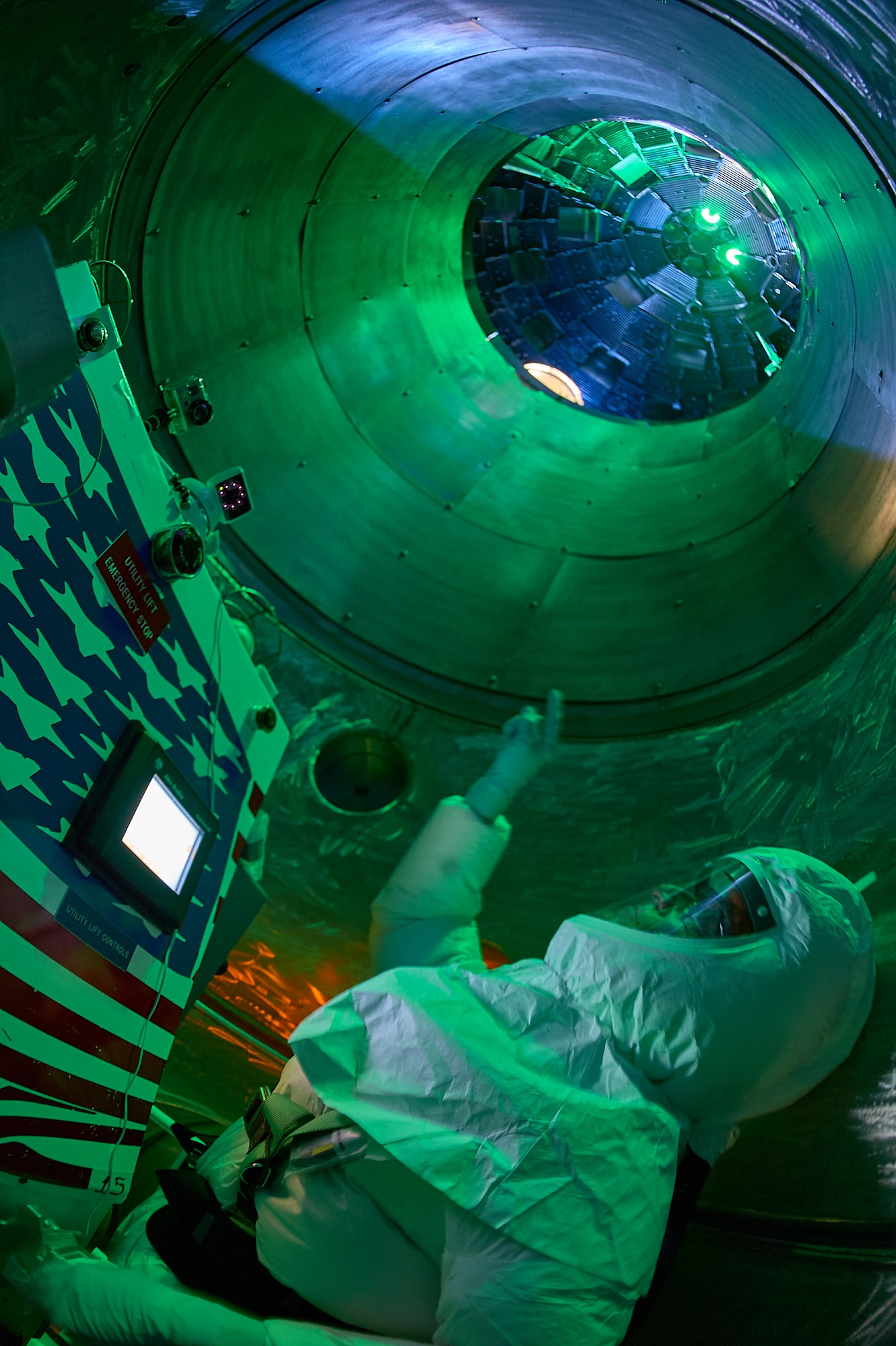 John R. Bower looks up from the TCSS (Target Chamber Service System) as it makes its way inside of the target chamber at NIF.

