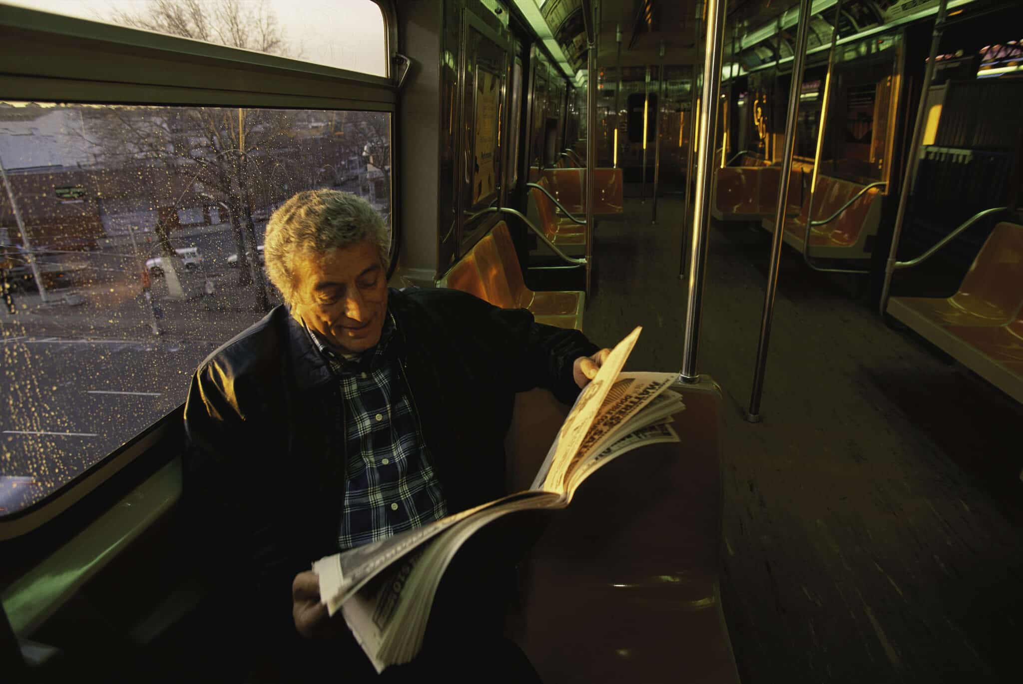 Tony Bennett on the subway reading the newspaper